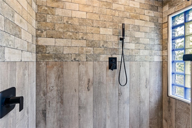 interior details featuring a tile shower