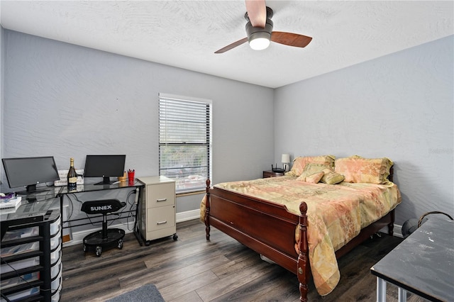 bedroom with a textured ceiling, ceiling fan, and dark wood-type flooring