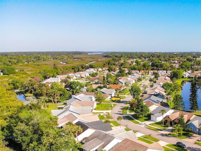 drone / aerial view featuring a residential view and a water view