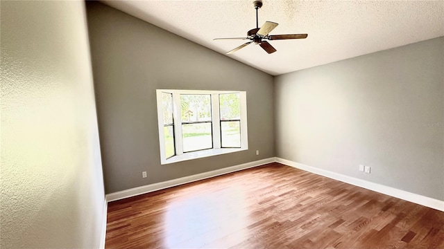 unfurnished room featuring hardwood / wood-style floors, a textured ceiling, ceiling fan, and lofted ceiling