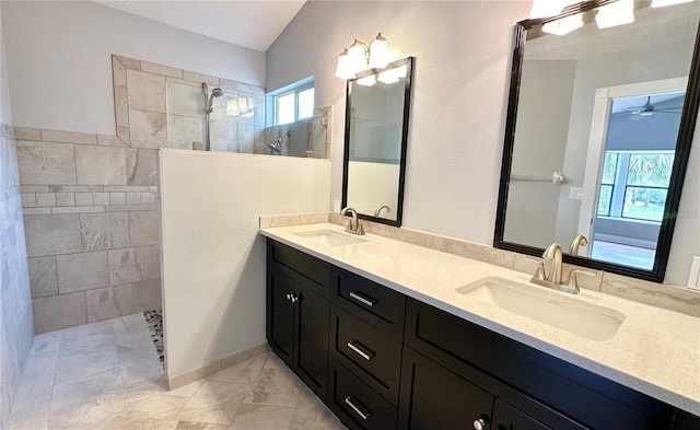 bathroom featuring vanity, ceiling fan, and tiled shower