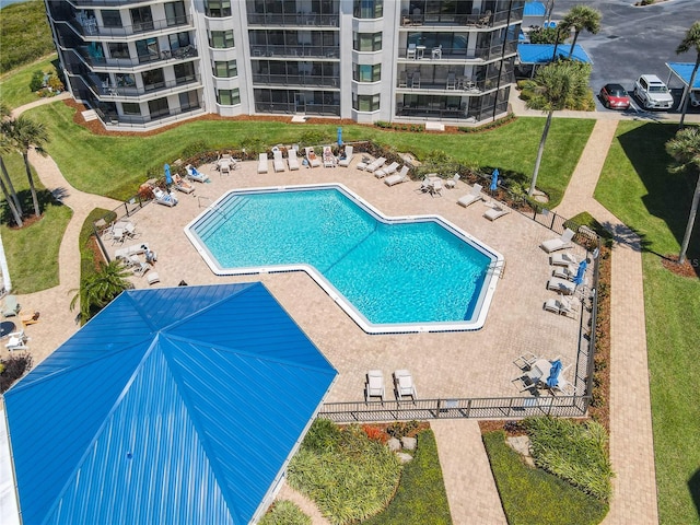 view of pool featuring a patio area and a lawn