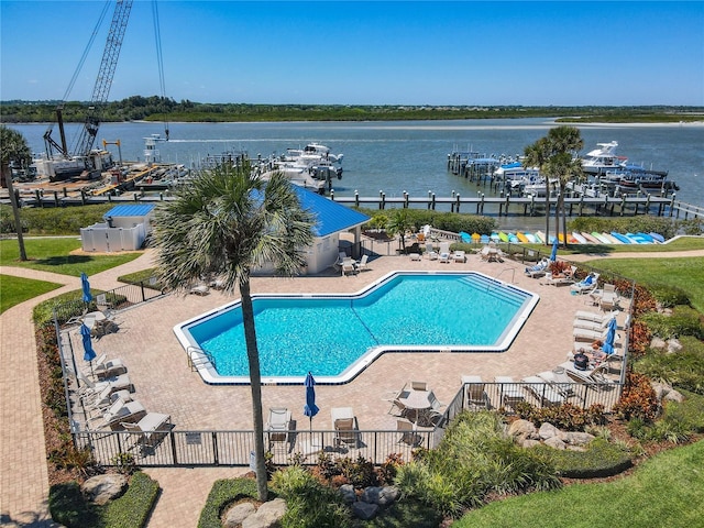 view of swimming pool featuring a patio area and a water view