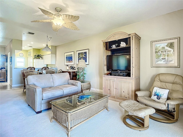 living room featuring light colored carpet and ceiling fan