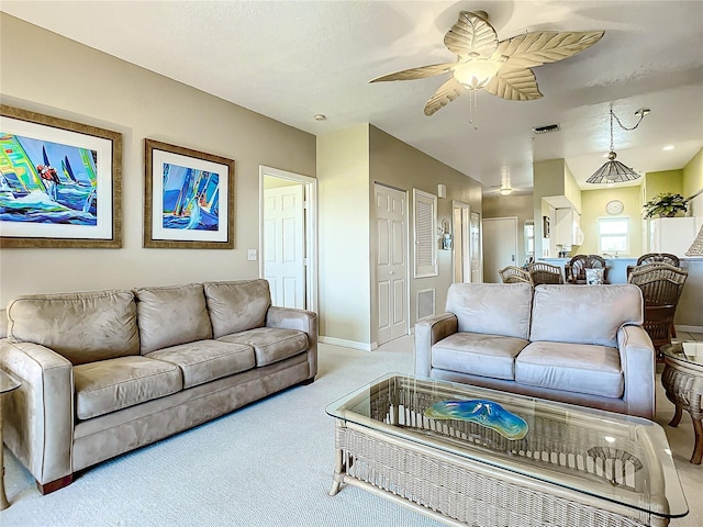 living room with light colored carpet and ceiling fan