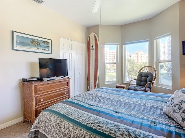 carpeted bedroom with a closet and ceiling fan