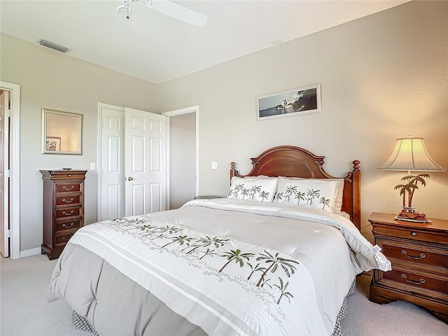 bedroom with a closet, light colored carpet, and ceiling fan