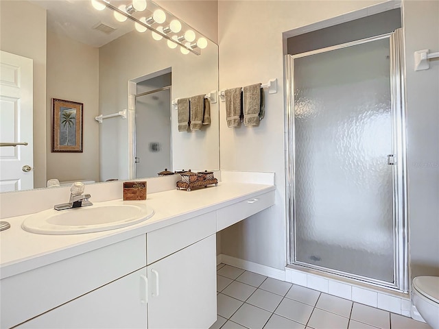 bathroom featuring toilet, walk in shower, vanity, and tile patterned floors