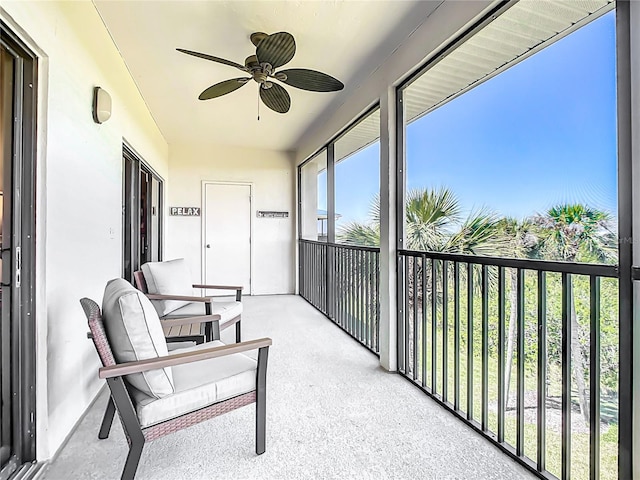 sunroom / solarium featuring ceiling fan