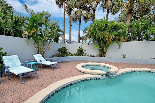 view of swimming pool with a patio area and an in ground hot tub