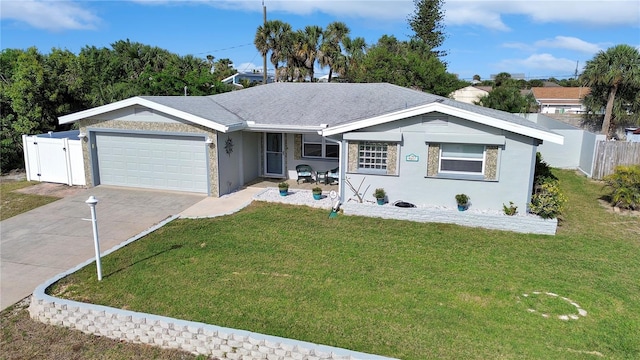 ranch-style house featuring fence, an attached garage, stucco siding, a front lawn, and concrete driveway