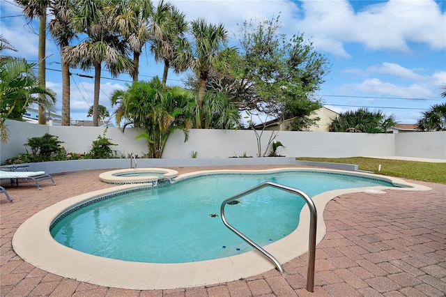 view of swimming pool with an in ground hot tub and a patio area