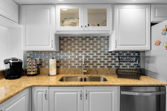 kitchen featuring white cabinets, appliances with stainless steel finishes, backsplash, and sink