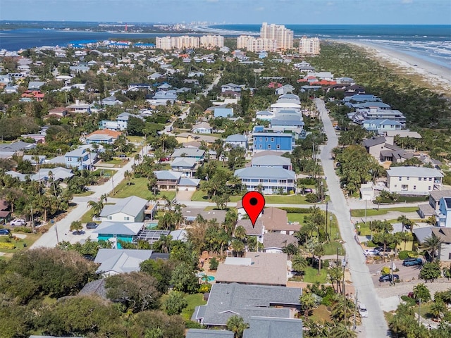 drone / aerial view with a water view and a view of the beach