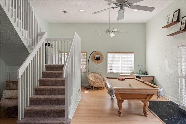 rec room featuring a textured ceiling, wood-type flooring, billiards, and ceiling fan