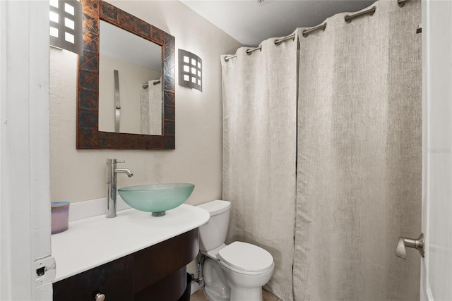 bathroom with toilet, vanity, and a shower with shower curtain