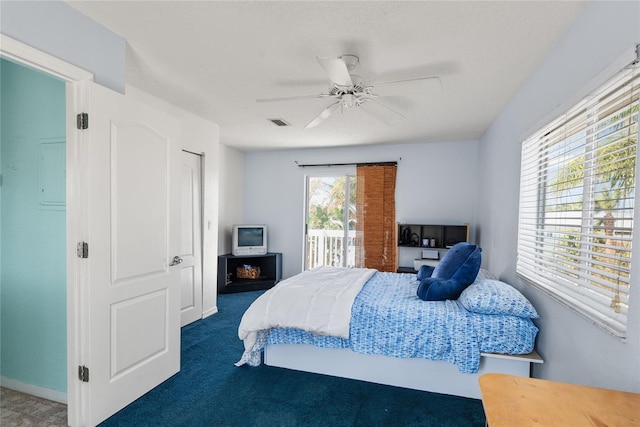 carpeted bedroom featuring multiple windows, access to outside, and ceiling fan