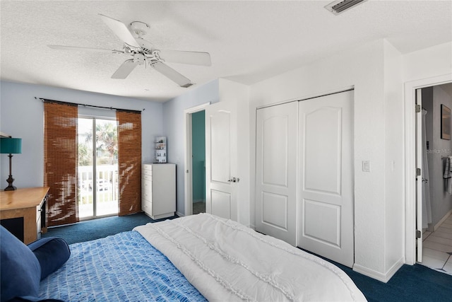 bedroom with dark colored carpet, a closet, access to outside, a textured ceiling, and ceiling fan