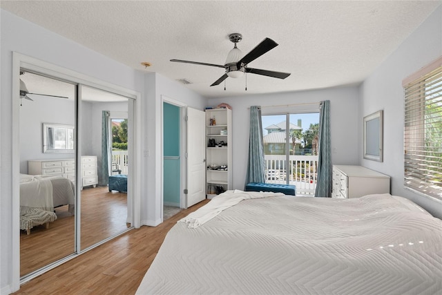 bedroom with a closet, ceiling fan, access to outside, and multiple windows