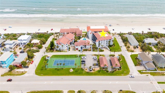 drone / aerial view with a water view and a beach view