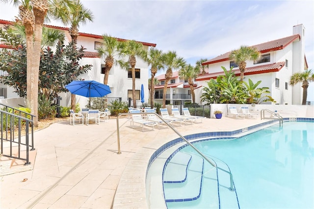 view of swimming pool featuring a patio area