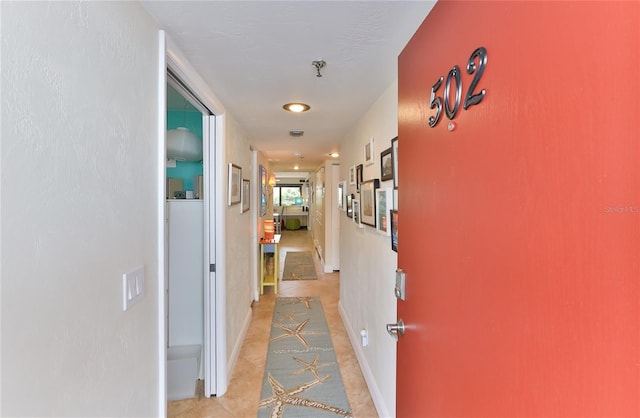 hallway featuring light tile patterned floors