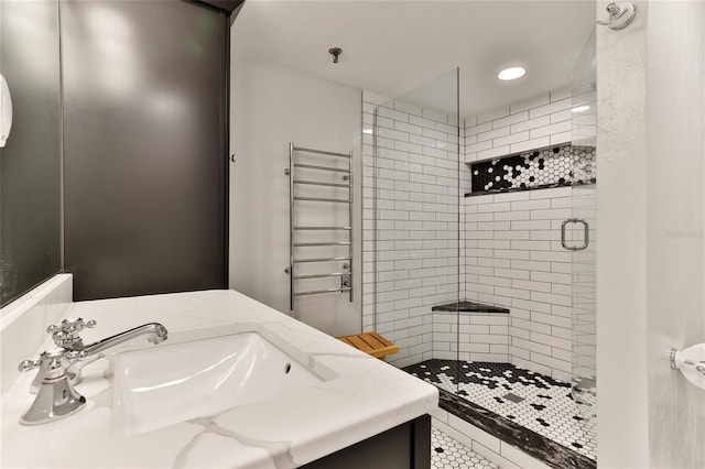 bathroom with vanity, radiator, tile patterned floors, and a shower with door