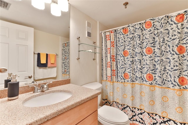 bathroom featuring curtained shower, vanity, and toilet