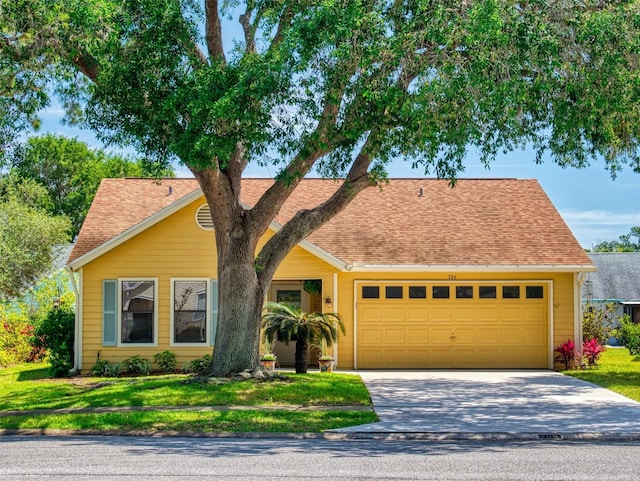 view of front of house with a garage and a front yard