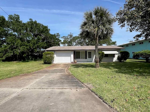 single story home featuring a garage and a front lawn