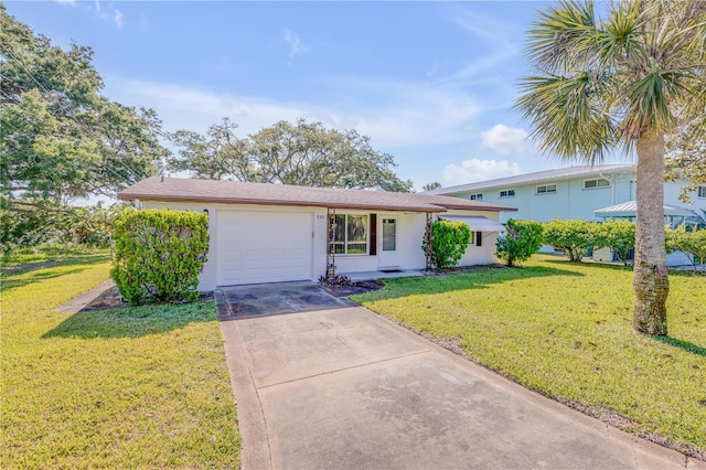 view of front of property featuring a front lawn and a garage