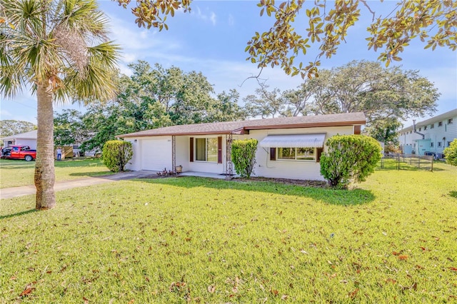 ranch-style home with a front yard and a garage