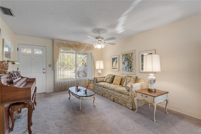 living room featuring a textured ceiling, ceiling fan, and carpet flooring