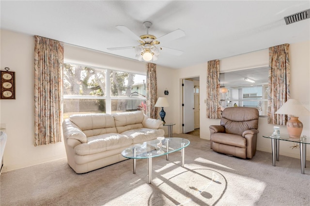 carpeted living room with ceiling fan