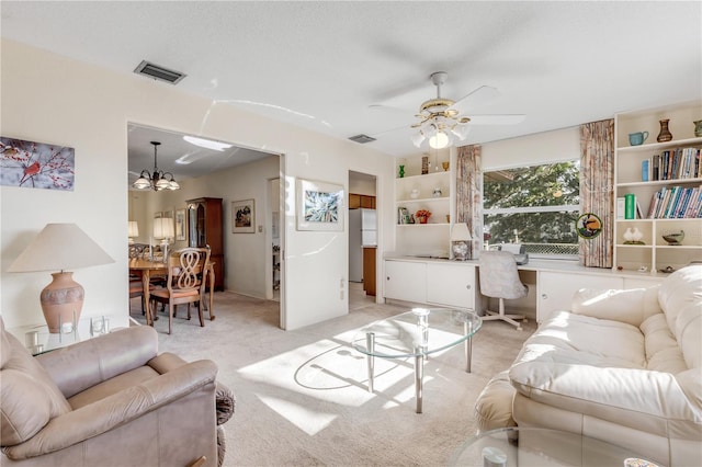 carpeted living room featuring ceiling fan