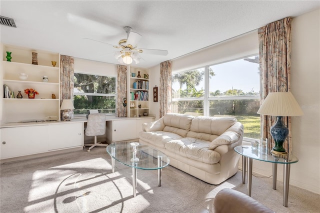 living room with light carpet and ceiling fan