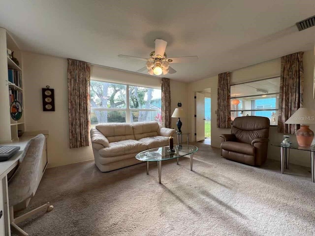 living room featuring carpet and ceiling fan