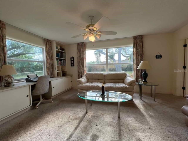 living room featuring ceiling fan and carpet