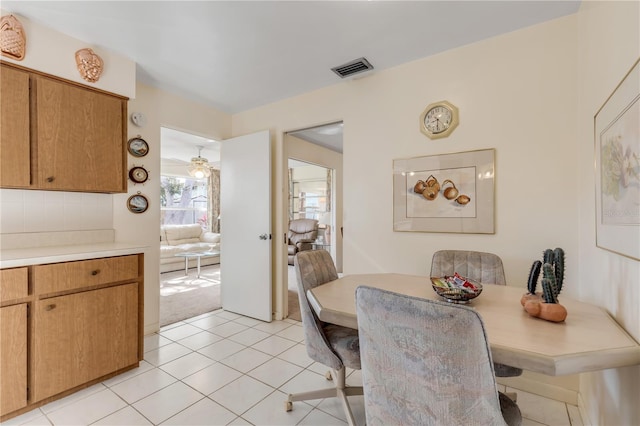 dining room with ceiling fan and light tile flooring