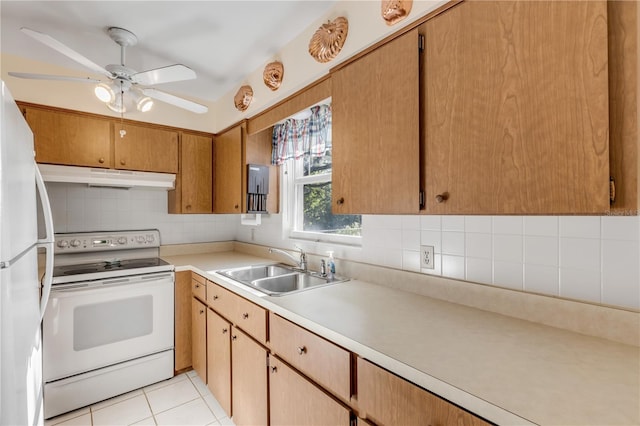 kitchen featuring backsplash, white appliances, sink, and light tile floors