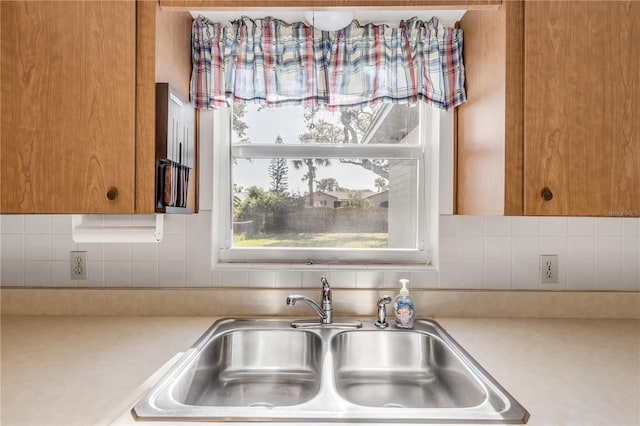 kitchen featuring sink and tasteful backsplash