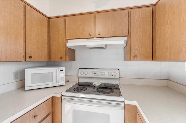 kitchen featuring white appliances and tasteful backsplash