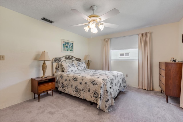 carpeted bedroom with a textured ceiling and ceiling fan