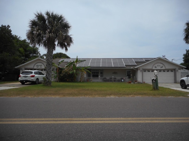 single story home with a garage and solar panels