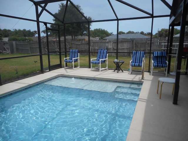 view of pool featuring a patio, a yard, and a lanai