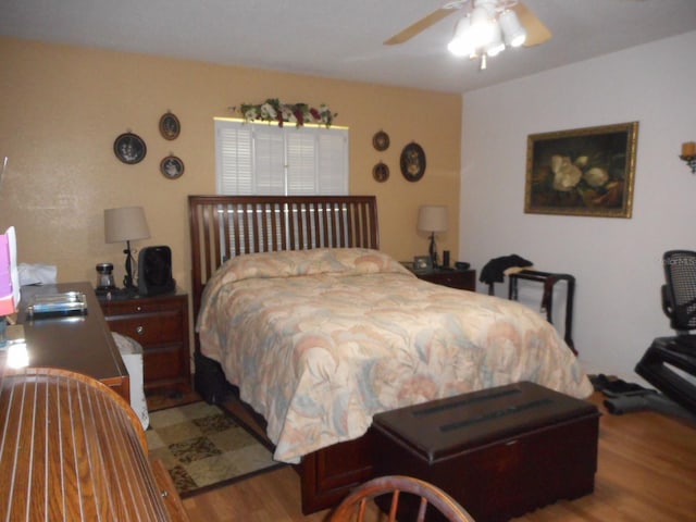 bedroom with wood-type flooring and ceiling fan