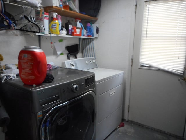 laundry room featuring washer and dryer and a wealth of natural light