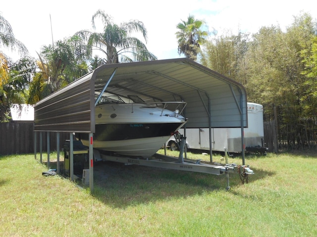 view of parking with a carport and a lawn