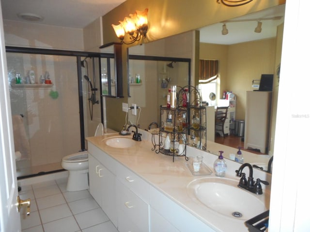 bathroom with dual vanity, an enclosed shower, tile patterned flooring, and toilet