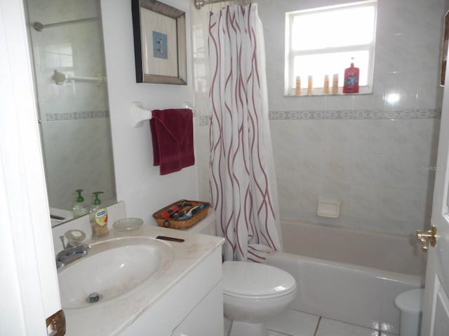 full bathroom with tile patterned flooring, shower / bath combination with curtain, toilet, and vanity